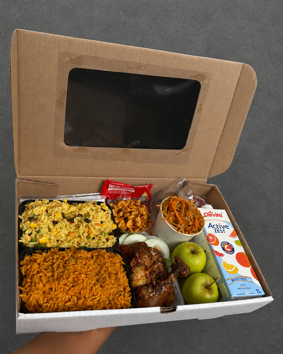 Window gift box with jollof rice, chicken, fruit and juice
